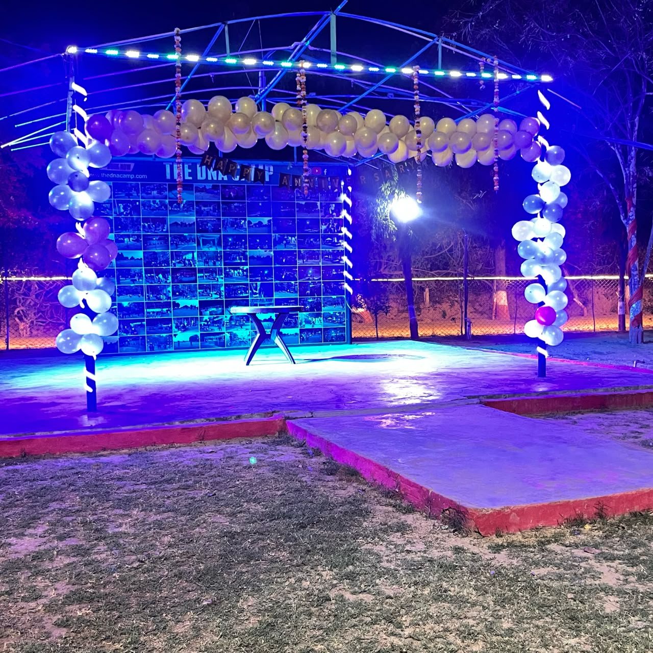 The stage and DJ setup lit up for an evening event