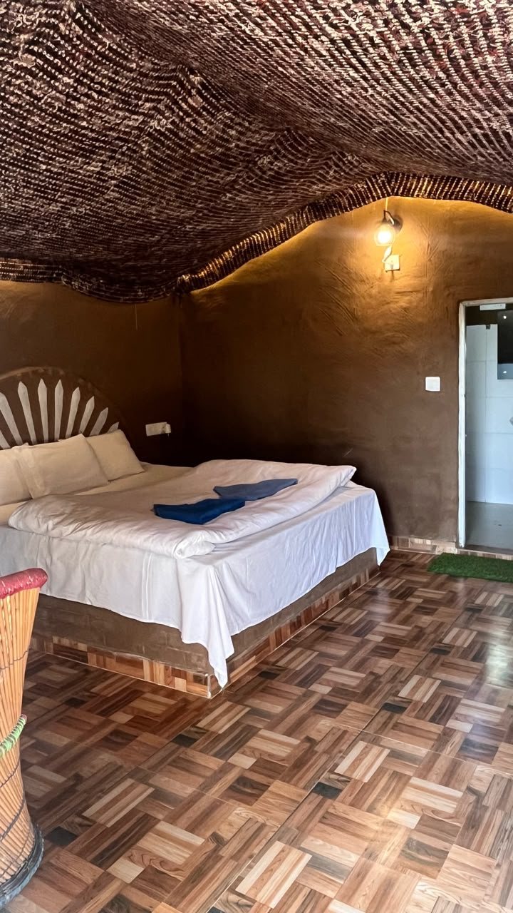 Swiss cottage interior with a double bed and attached bathroom