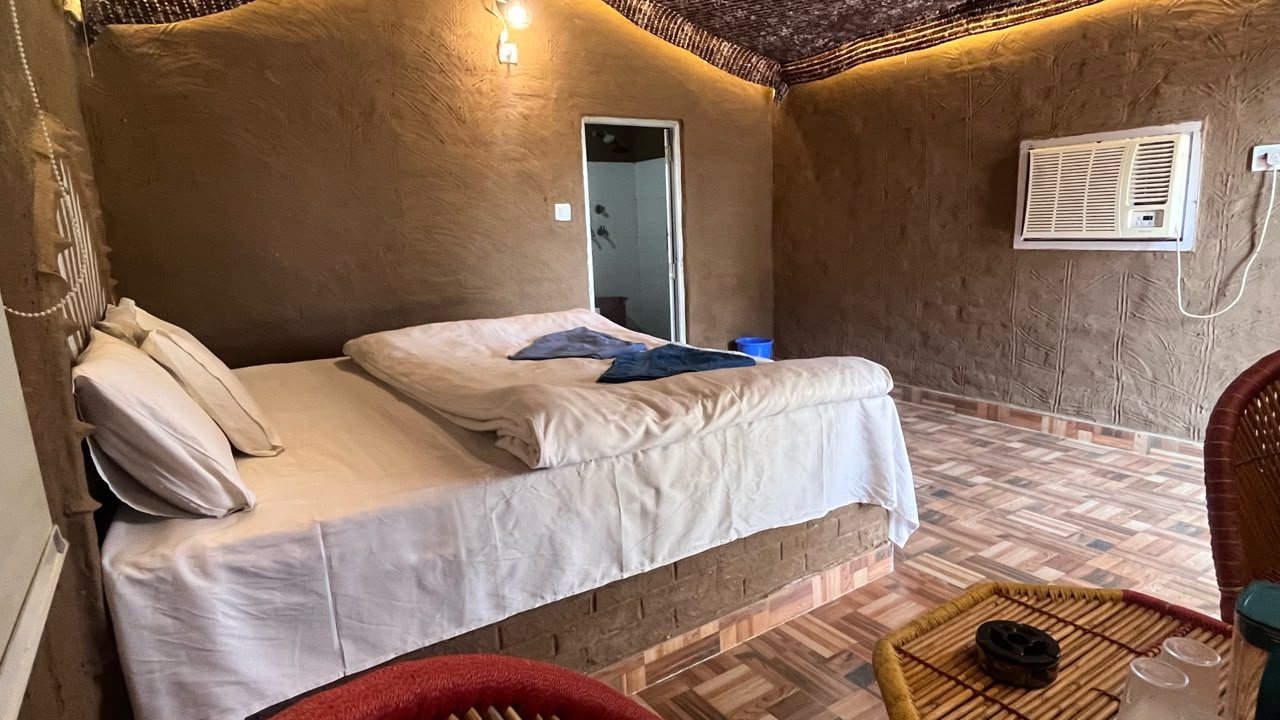 Inside a Swiss cottage with a double bed and warm lighting